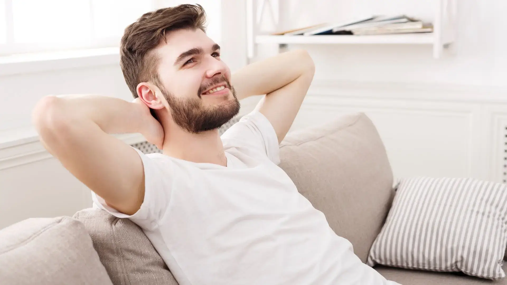 Relaxed homeowner sitting on a couch