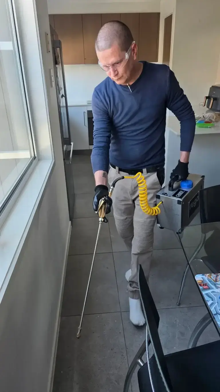 Pest Control Technician Treating Property